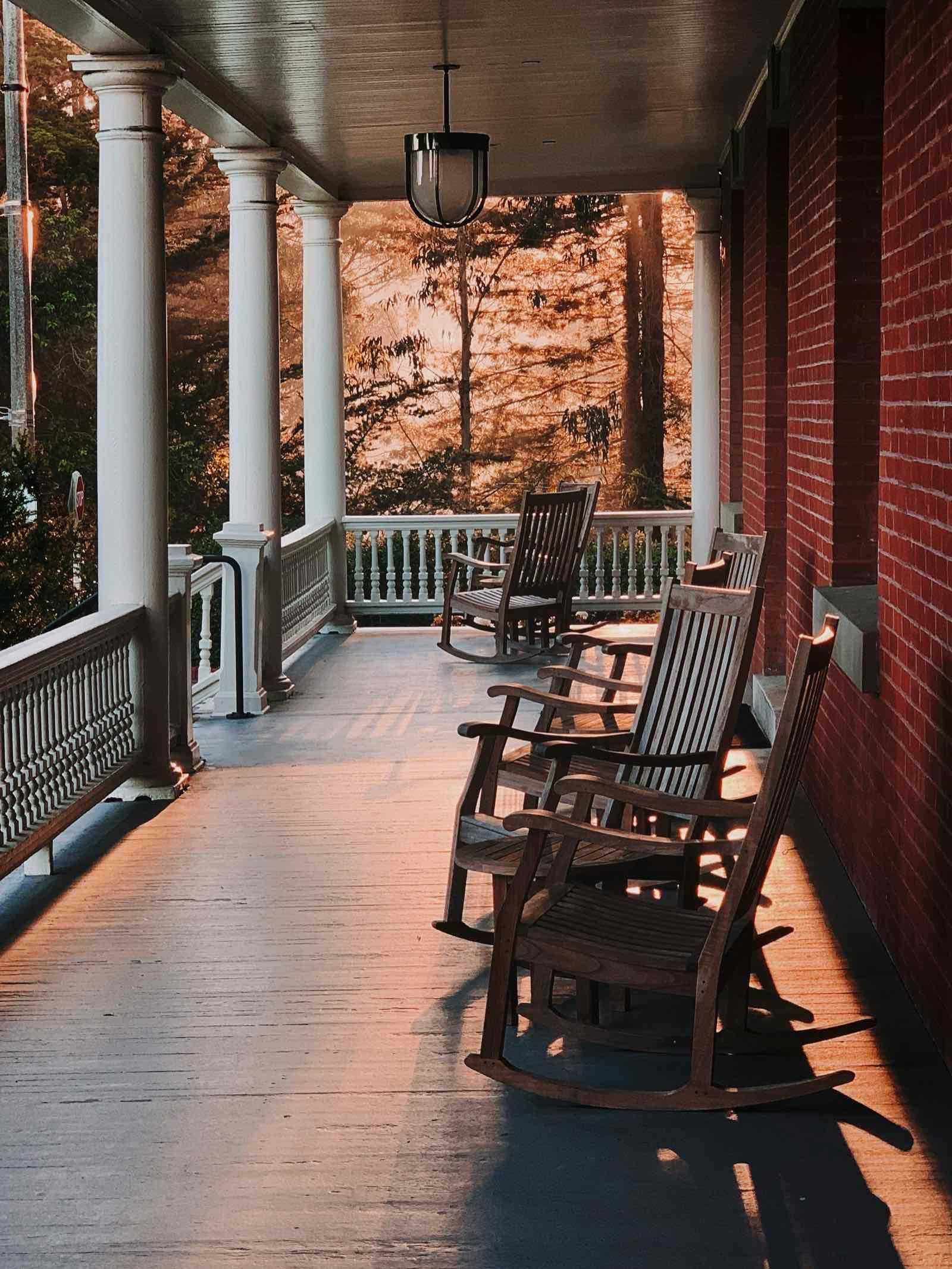A Connecticut home at dusk with warm porch and window lights on