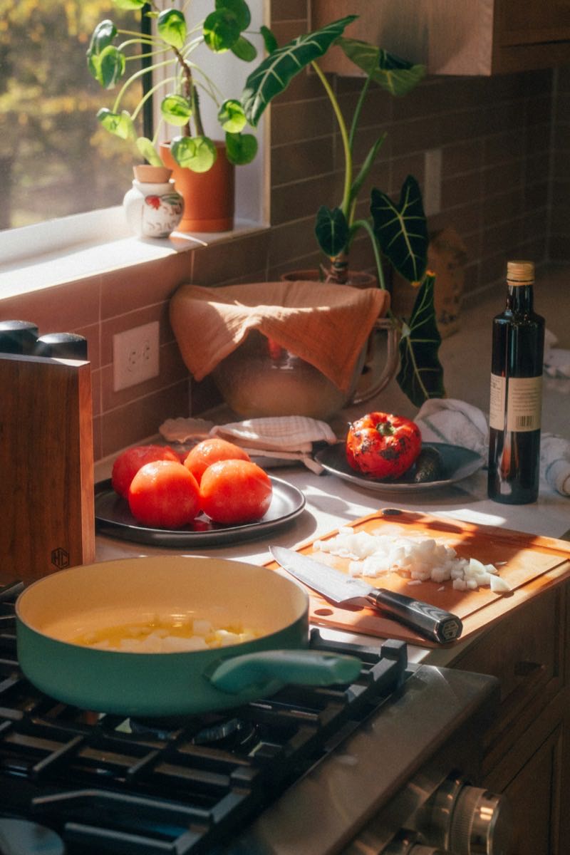 A sunlit home kitchen with a fresh home-cooked meal on the table